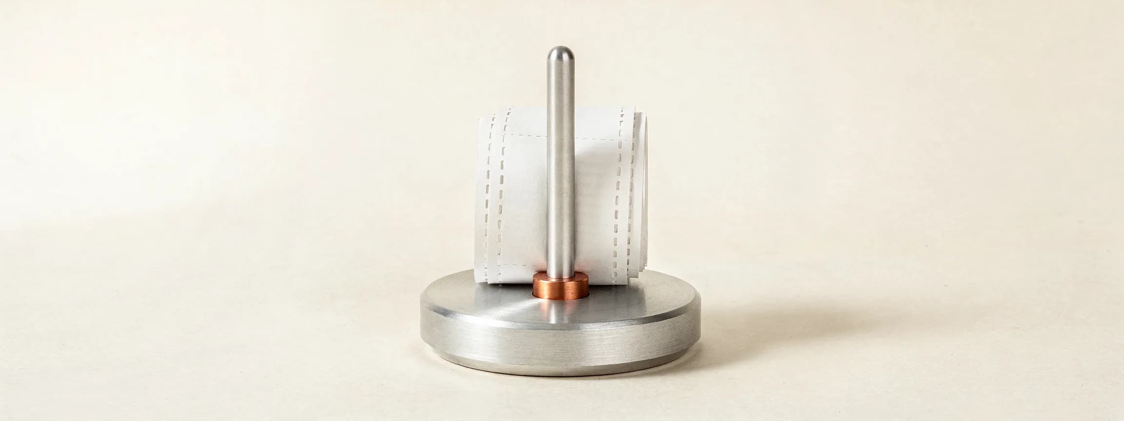 A roll of receipts on a steel spindle.